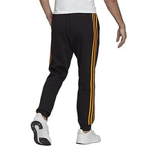 Load image into Gallery viewer, adidas Men's Essentials Fleece Tapered Cuff 3-Stripes Pants, Black/Semi Solar Gold, X-Small
